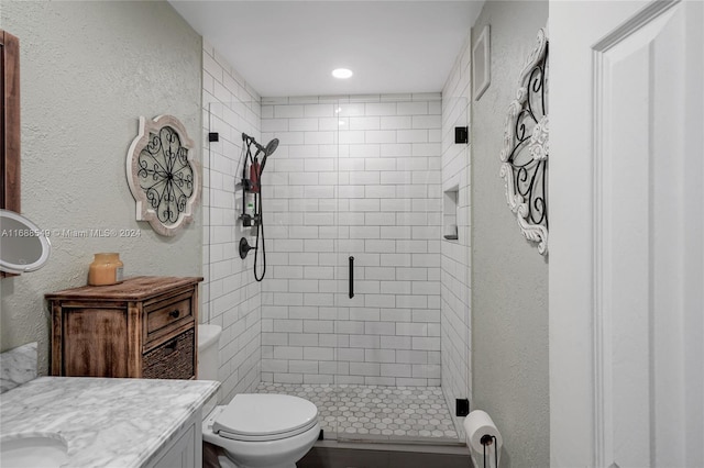 bathroom featuring walk in shower, vanity, and toilet