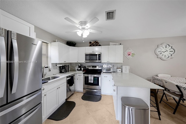 kitchen featuring white cabinetry, sink, and appliances with stainless steel finishes