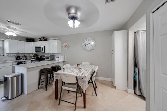 dining room with ceiling fan and light tile patterned floors