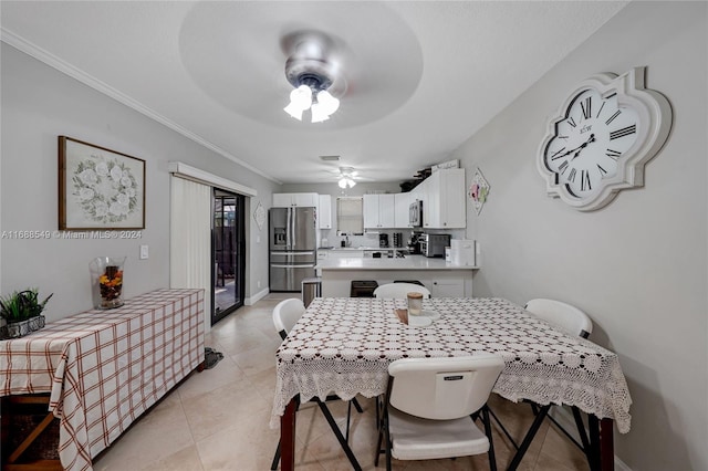 tiled dining room with ornamental molding and ceiling fan