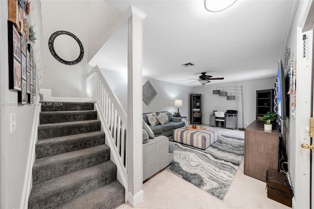 tiled living room with ceiling fan