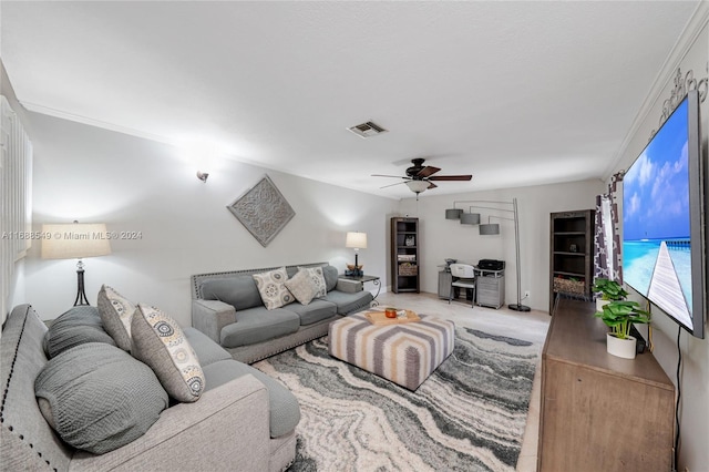 carpeted living room with ornamental molding and ceiling fan