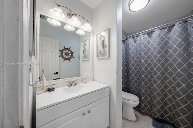 bathroom with vanity, walk in shower, tile patterned floors, and toilet