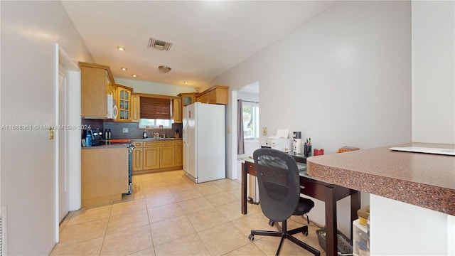 kitchen with backsplash, light tile patterned flooring, and white appliances