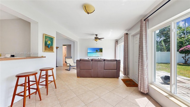 tiled living room featuring ceiling fan