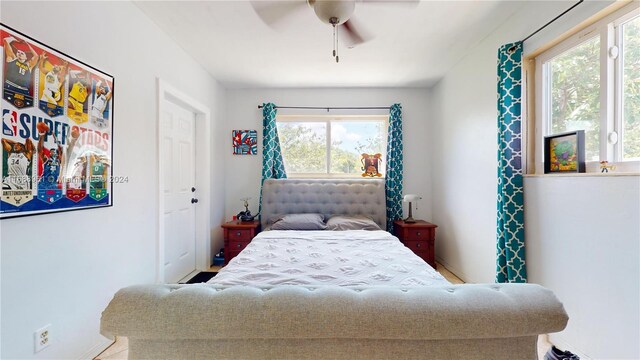 bedroom featuring ceiling fan and multiple windows