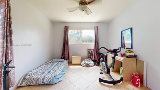 bedroom with ceiling fan and light tile patterned flooring