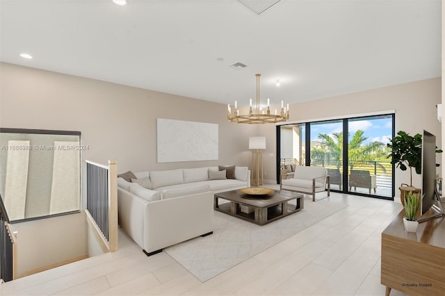 living room featuring a notable chandelier and light hardwood / wood-style flooring