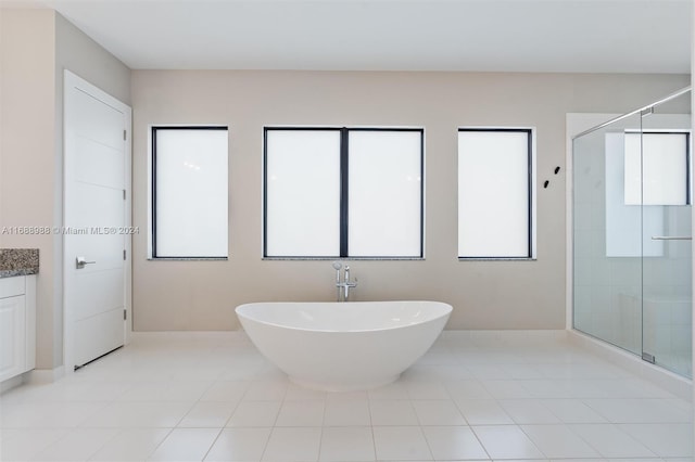 bathroom with shower with separate bathtub and vanity