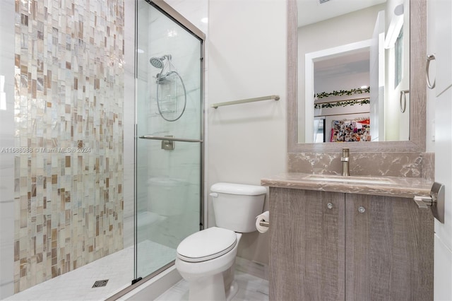 bathroom with vanity, toilet, and an enclosed shower