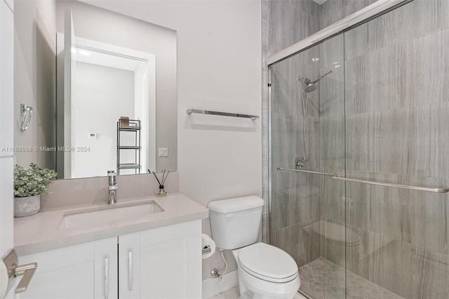 bathroom with vanity, toilet, and an enclosed shower