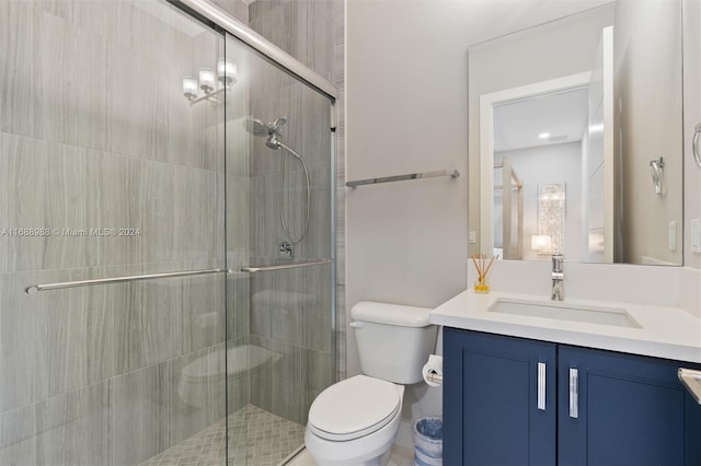 bathroom featuring toilet, vanity, and an enclosed shower