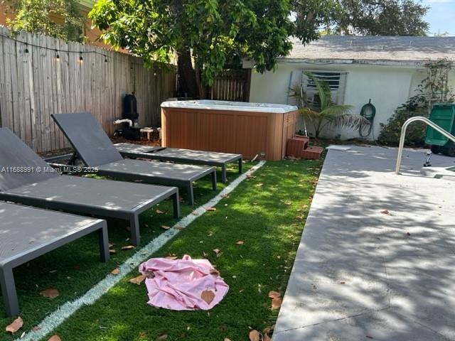 view of yard featuring sink and a hot tub