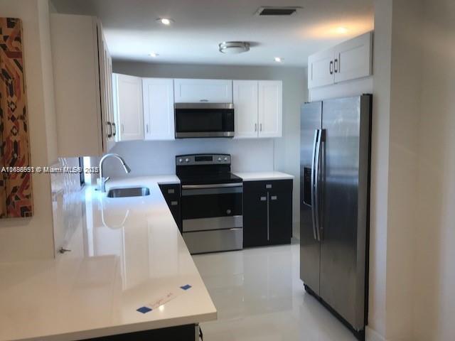 kitchen featuring white cabinets, sink, and stainless steel appliances