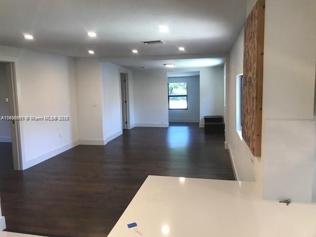 spare room featuring dark wood-type flooring