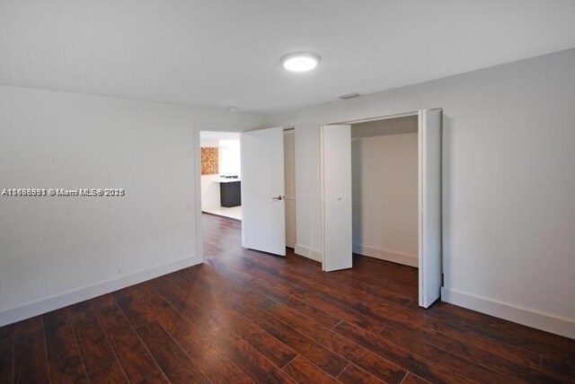 empty room featuring dark wood-type flooring