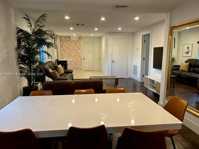 dining space with recessed lighting, visible vents, and dark wood finished floors