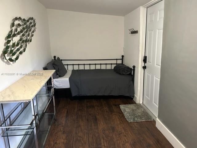 bedroom featuring dark wood-type flooring