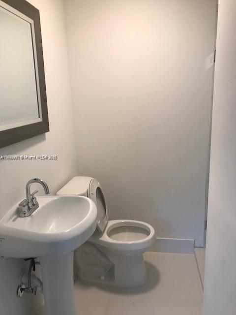 bathroom featuring tile patterned flooring and toilet