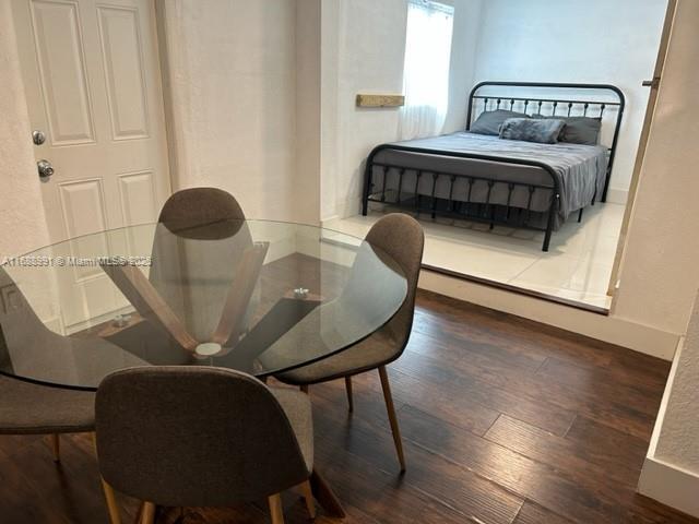 dining space featuring dark wood-type flooring