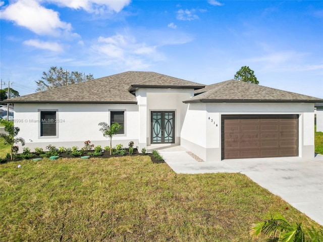 prairie-style home with a front yard and a garage