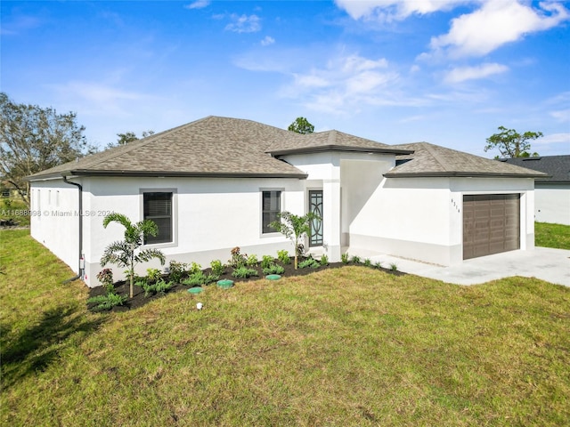 view of front of house with a front yard and a garage