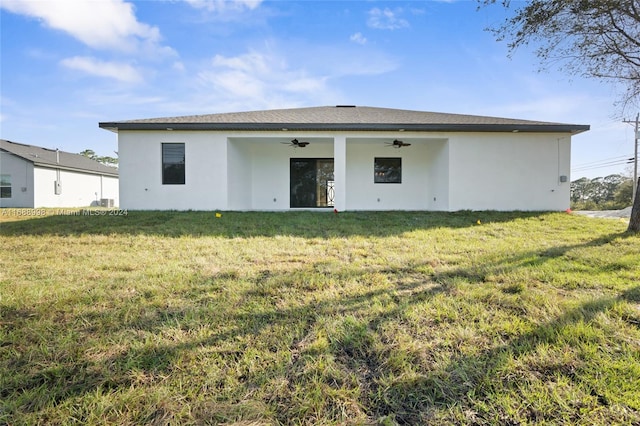 back of house featuring ceiling fan and a lawn