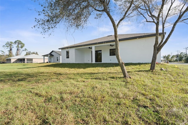 rear view of house featuring a yard