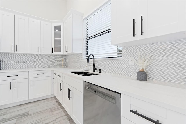 kitchen with white cabinets, sink, dishwasher, and tasteful backsplash