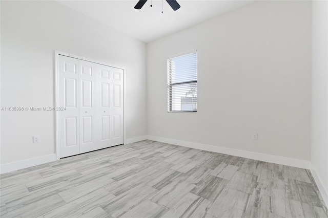 unfurnished bedroom with a closet, light hardwood / wood-style floors, and ceiling fan