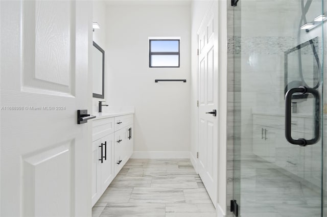 bathroom featuring walk in shower and vanity