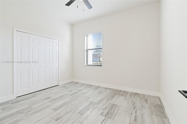 unfurnished bedroom featuring light hardwood / wood-style floors, ceiling fan, and a closet