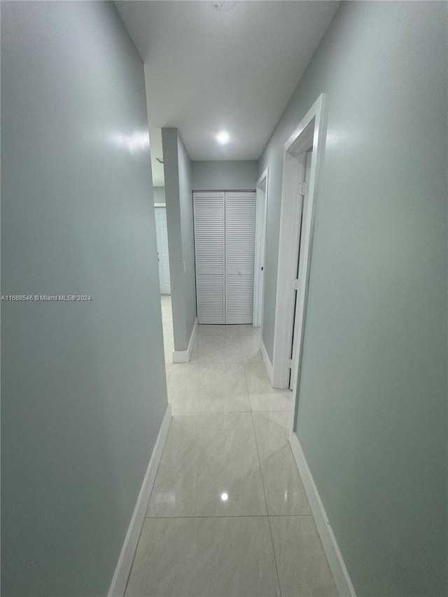 corridor with light tile patterned floors