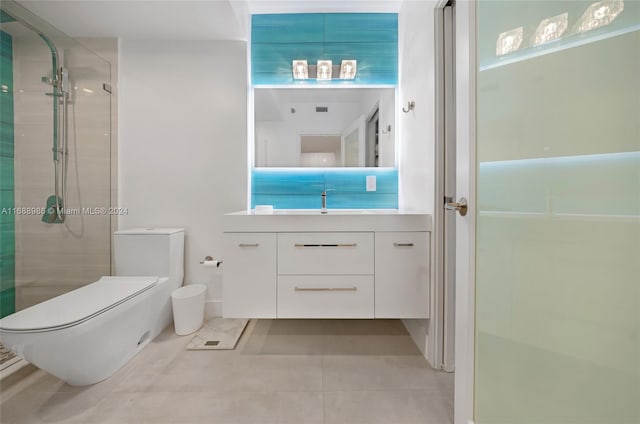 bathroom with toilet, vanity, tile patterned flooring, and a shower with shower door