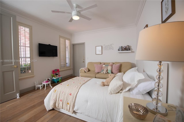 bedroom featuring hardwood / wood-style flooring, ceiling fan, and crown molding