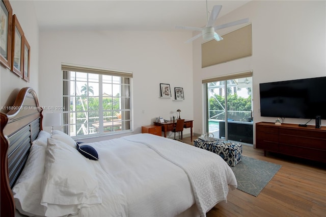 bedroom with ceiling fan, light hardwood / wood-style flooring, and high vaulted ceiling