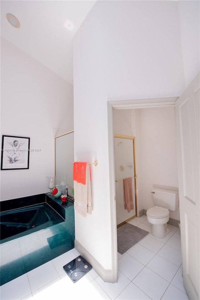 bathroom with toilet, independent shower and bath, tile patterned floors, and vaulted ceiling