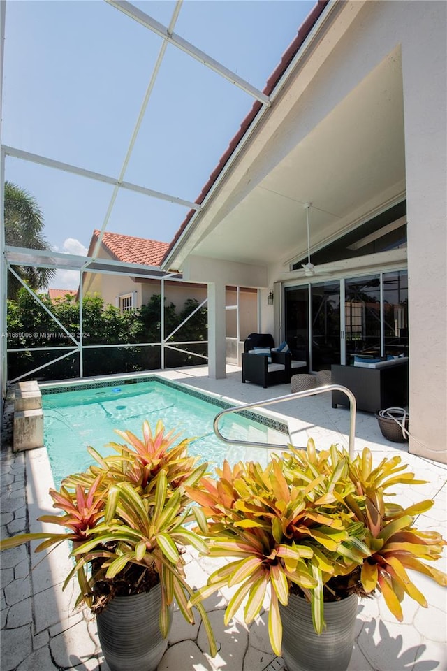 view of pool featuring ceiling fan, a lanai, and a patio area