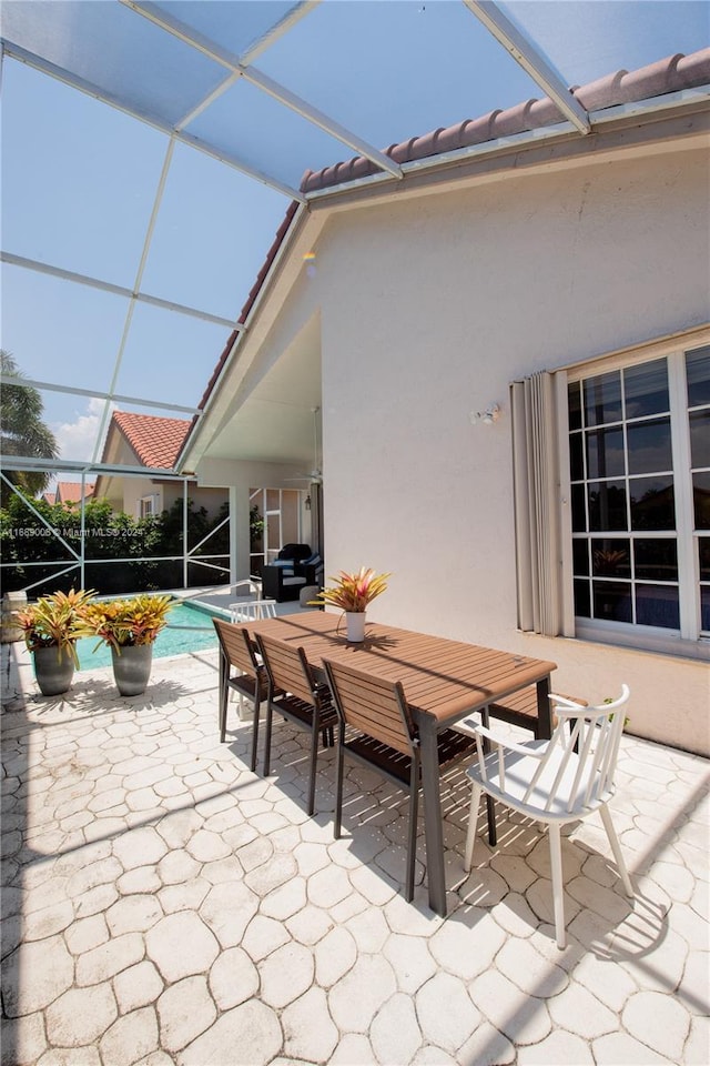 view of patio / terrace featuring a lanai