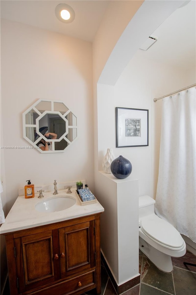 bathroom featuring toilet and vanity