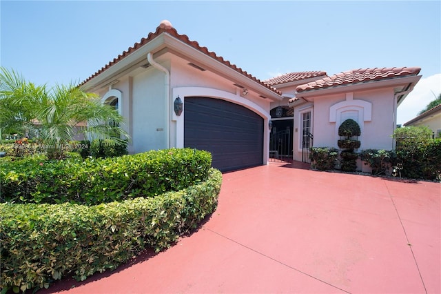 mediterranean / spanish house featuring a garage