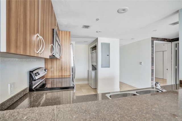 kitchen with electric panel, appliances with stainless steel finishes, sink, and light tile patterned flooring