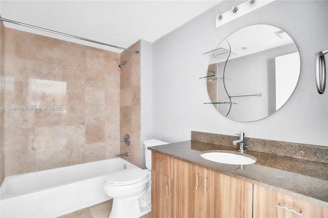 full bathroom featuring tile patterned floors, vanity, tiled shower / bath combo, and toilet