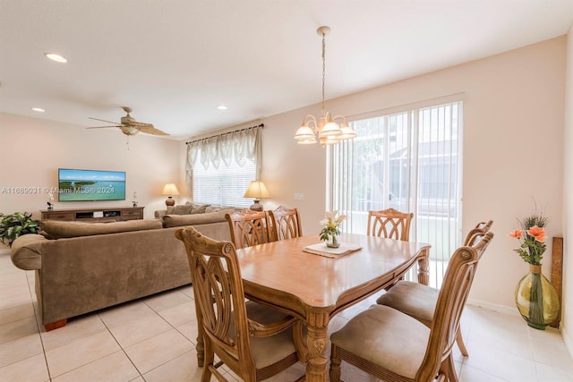 dining area featuring light tile patterned floors and ceiling fan with notable chandelier