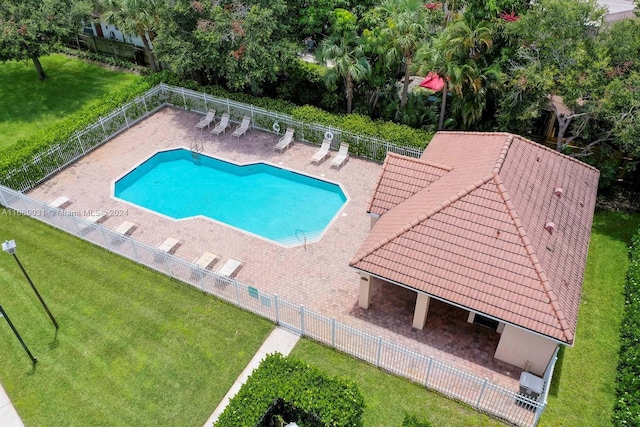 view of pool with a patio and a yard