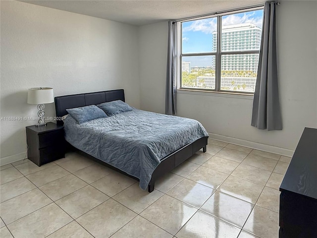 bedroom featuring light tile patterned floors