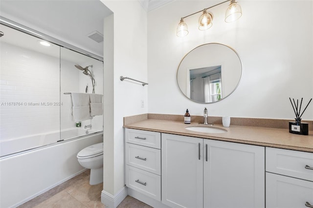 full bathroom featuring tile patterned flooring, shower / bath combination with glass door, toilet, and vanity