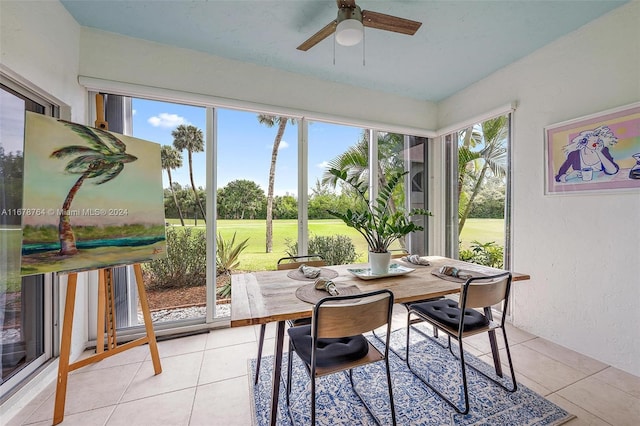 sunroom featuring ceiling fan and plenty of natural light