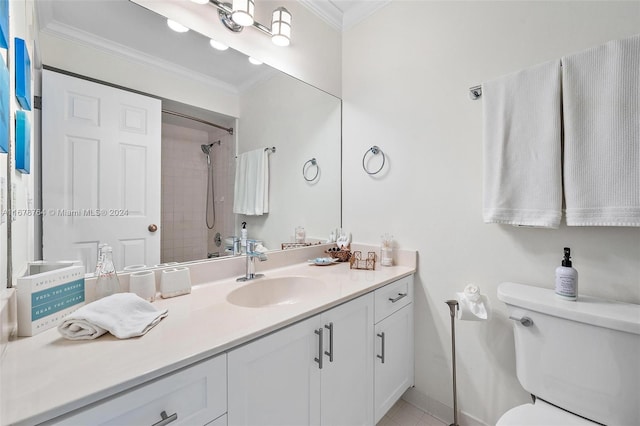 bathroom featuring toilet, vanity, a tile shower, and ornamental molding