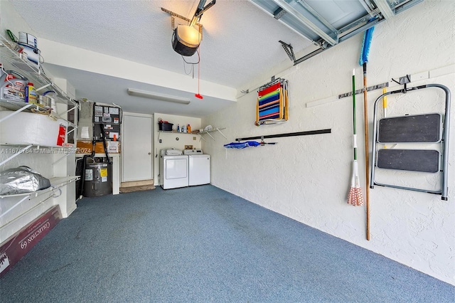 garage with a garage door opener and washing machine and clothes dryer